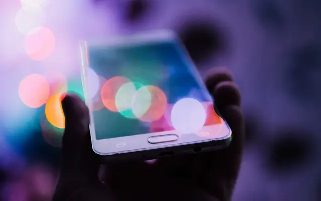 Pessoa segurando o celular, recebendo atendimento por inteligência artificial